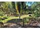 Lush green lawn area with trees and a wooden walkway at 2723 Orchid Oaks Dr # 104, Sarasota, FL 34239