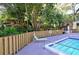 Relaxing pool area with wooden fence and lush foliage at 2723 Orchid Oaks Dr # 104, Sarasota, FL 34239