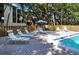 Sun bathe on the lounge chairs near the pool at 2723 Orchid Oaks Dr # 104, Sarasota, FL 34239