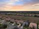 Luxury homes community with golf course and preserve views at sunset at 2763 Phoenix Palm Ter, North Port, FL 34288