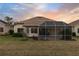 Home with screened patio and grassy backyard at 2763 Phoenix Palm Ter, North Port, FL 34288