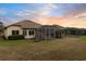 Home with screened patio and grassy backyard at 2763 Phoenix Palm Ter, North Port, FL 34288