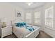 Bedroom with a queen bed and large windows with plantation shutters at 2763 Phoenix Palm Ter, North Port, FL 34288