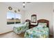 Guest bedroom with twin beds and large window at 2763 Phoenix Palm Ter, North Port, FL 34288