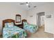 Bright bedroom with twin beds and a view of the hallway at 2763 Phoenix Palm Ter, North Port, FL 34288