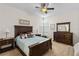 Spacious bedroom with a large bed, dresser, and ceiling fan at 2763 Phoenix Palm Ter, North Port, FL 34288