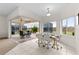 Breakfast nook with glass table and chairs, sliders open to screened patio at 2763 Phoenix Palm Ter, North Port, FL 34288