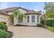 One story house with circular driveway and palm trees at 2763 Phoenix Palm Ter, North Port, FL 34288