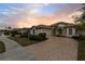 One-story home with a tile roof, and a large driveway at 2763 Phoenix Palm Ter, North Port, FL 34288