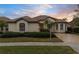 Tan one-story house with tile roof, and landscaped yard at 2763 Phoenix Palm Ter, North Port, FL 34288