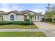 One story house with circular driveway and palm trees at 2763 Phoenix Palm Ter, North Port, FL 34288