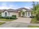 One story house with circular driveway and palm trees at 2763 Phoenix Palm Ter, North Port, FL 34288