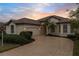 One story house with circular driveway and palm trees at 2763 Phoenix Palm Ter, North Port, FL 34288