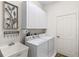 Laundry room with washer, dryer, and utility sink at 2763 Phoenix Palm Ter, North Port, FL 34288