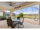 Relaxing screened patio with table and chairs, overlooking backyard at 2763 Phoenix Palm Ter, North Port, FL 34288