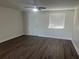 Spacious living room with dark laminate flooring and ceiling fan at 2807 W 52Nd Ter, Bradenton, FL 34207