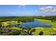 Aerial view of golf course with lake and ocean views at 282 Shell Midden Ct, Osprey, FL 34229