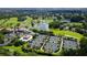 Aerial view of community, featuring golf course, tennis courts, and lake at 282 Shell Midden Ct, Osprey, FL 34229