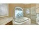 Elegant bathroom, featuring a large soaking tub and marble finishes at 282 Shell Midden Ct, Osprey, FL 34229