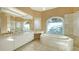 Bathroom with marble flooring, bathtub, and dual sinks at 282 Shell Midden Ct, Osprey, FL 34229