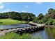 Wooden bridge over water on golf course at 282 Shell Midden Ct, Osprey, FL 34229