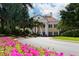 Luxury clubhouse entrance with landscaping and palm trees at 282 Shell Midden Ct, Osprey, FL 34229