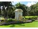 The Oaks Club entrance with lush landscaping and eagle statue at 282 Shell Midden Ct, Osprey, FL 34229