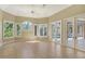 Bright Gathering room with tile floors, large windows, and access to pool at 282 Shell Midden Ct, Osprey, FL 34229