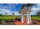 White gazebo with brick walkway in a lush green landscape at 282 Shell Midden Ct, Osprey, FL 34229