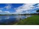 Serene lake view with lush greenery and clear blue sky at 282 Shell Midden Ct, Osprey, FL 34229