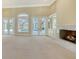 Living room with fireplace, built-ins, and access to the pool area at 282 Shell Midden Ct, Osprey, FL 34229