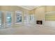 Living room with fireplace, built-ins, and pool views at 282 Shell Midden Ct, Osprey, FL 34229