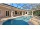 Resort-style pool and spa with covered patio and outdoor kitchen at 282 Shell Midden Ct, Osprey, FL 34229