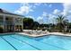 Inviting resort-style pool with lounge chairs and tennis courts nearby at 282 Shell Midden Ct, Osprey, FL 34229