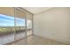 Bright bedroom with tiled floors and sliding glass doors leading to a balcony at 3010 Grand Bay Blvd # 493, Longboat Key, FL 34228