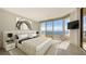 Spacious bedroom boasts a king-size bed, water views, and ample natural light at 3010 Grand Bay Blvd # 493, Longboat Key, FL 34228