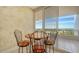 Breakfast nook with a small table and chairs near balcony at 3010 Grand Bay Blvd # 493, Longboat Key, FL 34228