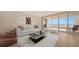 Bright living room with water views and balcony access at 3010 Grand Bay Blvd # 493, Longboat Key, FL 34228