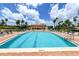 Large rectangular pool with plenty of lounge chairs at 3010 Grand Bay Blvd # 493, Longboat Key, FL 34228