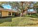 Large backyard with lush lawn and a mature oak tree at 3336 Tallywood Ct # 7084, Sarasota, FL 34237