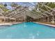 Community pool with screened enclosure at 3336 Tallywood Ct # 7084, Sarasota, FL 34237