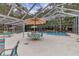 Screened pool area with tables and chairs at 3336 Tallywood Ct # 7084, Sarasota, FL 34237