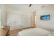 Bedroom with a queen bed, light wood floors, and multiple closets at 345 Madison Dr, Sarasota, FL 34236