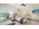 Bedroom with two twin beds, light wood floors and a mounted TV at 345 Madison Dr, Sarasota, FL 34236