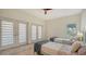 Bedroom with two twin beds, light wood floors and access to a balcony at 345 Madison Dr, Sarasota, FL 34236