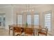 Light-filled dining room features a rustic wood table and modern chandelier at 345 Madison Dr, Sarasota, FL 34236