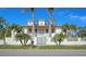 Two-story home with metal roof, gated entry, and artistic wall decor at 345 Madison Dr, Sarasota, FL 34236