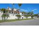 House with palm trees, white walls, and a metal roof at 345 Madison Dr, Sarasota, FL 34236