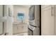 Bright laundry room features built-in cabinets and modern washer and dryer at 345 Madison Dr, Sarasota, FL 34236