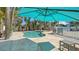 Inviting kidney-shaped pool with patio furniture under a teal umbrella at 345 Madison Dr, Sarasota, FL 34236